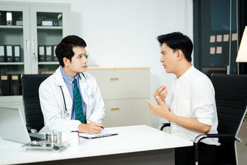 Fototapeta premium doctor supports stressed male patient during mental health consultation on sofa. Therapy, empathy, and emotional care