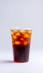 Cola cold drink with ice cubes, in plastic cup, isolated on a white studio background
