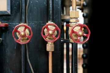 Old rustic industrial valve on metal pipe – vintage machinery detail