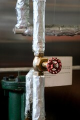 Old rustic industrial valve on metal pipe – vintage machinery detail