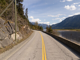 Scenic Rural Road with Mountain Views and River in BC, Canada