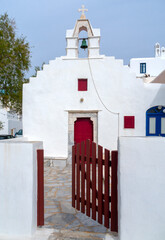 Beautiful white church with a cross on the island of Mykonos in Greece