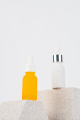 Plastic yellow tube for cream or lotion. Skin care or sunscreen cosmetic with stylish props on white background.