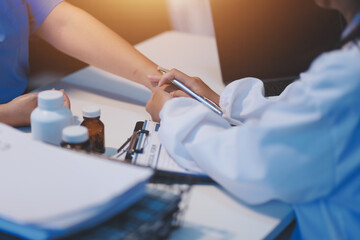 Doctor giving hope. Close up shot of young female physician leaning forward to smiling elderly lady patient holding her hand in palms. Woman caretaker in white coat supporting encouraging old person