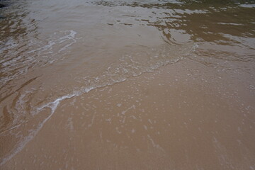 small wave in the white sand beach