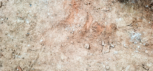 The floor texture of a collapsing building. Sand, cement, garbage.