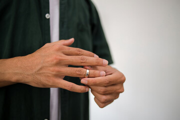 Man Removes a Wedding Ring From His Finger. Divorce Concept.