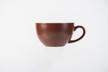 Coffee in a brown cup, coffee in a brown mug, coffee in a glass, cup on white background