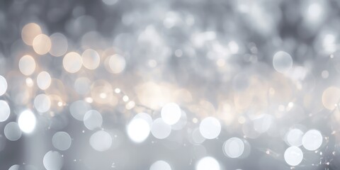 A silver and white bokeh background with a blurred, festive light effect.