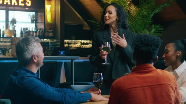 A Caucasian woman making a toast for her colleagues birthday