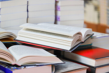 stack of books, close up. Open book on the table in library. Back to school concept.