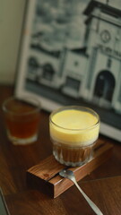egg cream coffee with a layer of coffee and milk on the bottom and a layer of egg cream on top