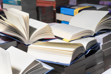 stack of books, close up. Open book on the table in library. Back to school concept.
