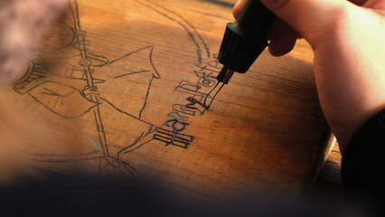Burn out the picture. Woodburning or pyrography. An artist drawing on a wooden plank with pyrograph. Wood burning ASMR creative hobby. Art class workshop. Creative activity. High quality 4k footage.