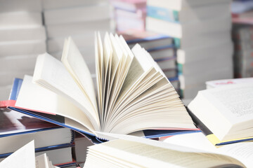 stack of books, close up. Open book on the table in library. Back to school concept.