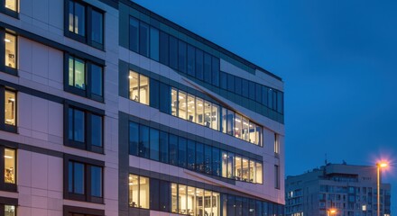 Modern building at dusk representing urban development and architecture, featuring illuminated windows