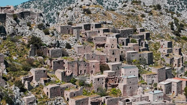 Ghost town Anavatos with ruined buildings on cliff on Chios island, Greece