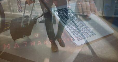 Walking traveler pulling suitcase on airport moving walkway, typing silver laptop code, copy space