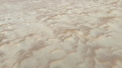 Intricate Patterns of Beach Sand Evoke Nature's Abstract Art, Showcasing the Delicate Impact of Wind and Water on Coastal Landscapes