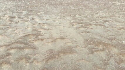 Close-up View of Intricate Sand Patterns Showcasing Nature's Artistry Shaped by Wind and Water at a Tranquil Beach