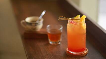 glass of peach orange lemongrass tea in a cafe