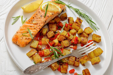 Oven-baked salmon fillet with fried potato, lemon