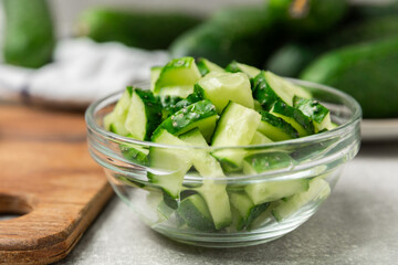 Cucumber on wooden background. Slice of cucumber on background. Fresh organic green cucumbers gherkin. Vegan. Salad ingredient. Farm vegetables. Cut vegetables with knife. Space for text. Copy space