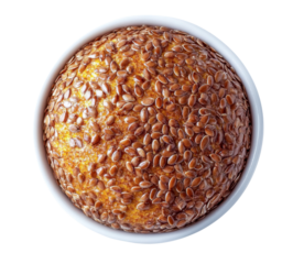 flax seed bread loaf in white bowl, overhead view