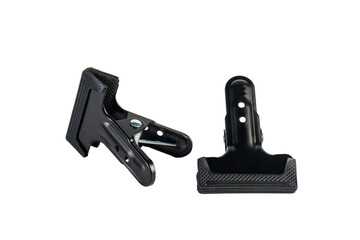 Black plastic spring clamp isolated on transparent background.
