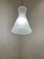 View of a cozy decorative lamp in a corner spending soft light