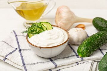 Cucumber sour cream tzatziki sauce on a wooden table.Tartar sauce. Traditional delicious appetizer. yogurt sauce. Tzatziki with ingredients cucumber, garlic,dill,lemon,mint. salad dressing.Copy space