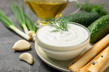 Cucumber sour cream tzatziki sauce on a wooden table.Tartar sauce. Traditional delicious appetizer. yogurt sauce. Tzatziki with ingredients cucumber, garlic,dill,lemon,mint. salad dressing.Copy space
