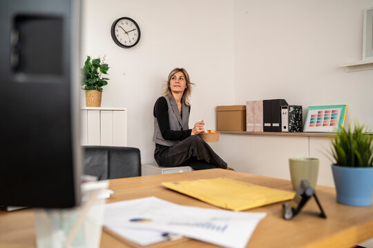 Woman taking a lunch break in a modern office setting