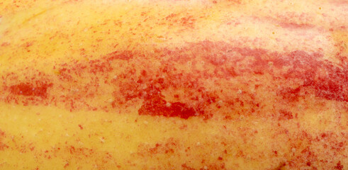 Red apple skin macro texture. Honeycrisp fruit surface close up, fresh spotted and striped apple