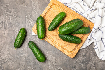 Cucumber on wooden background. Slice of cucumber on background. Fresh organic green cucumbers gherkin. Vegan. Salad ingredient. Farm vegetables. Cut vegetables with knife. Space for text. Copy space