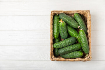 Cucumber on wooden background. Slice of cucumber on background. Fresh organic green cucumbers gherkin. Vegan. Salad ingredient. Farm vegetables. Cut vegetables with knife. Space for text. Copy space