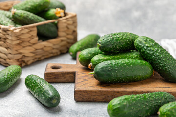 Cucumber on wooden background. Slice of cucumber on background. Fresh organic green cucumbers gherkin. Vegan. Salad ingredient. Farm vegetables. Cut vegetables with knife. Space for text. Copy space