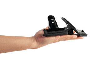 Black plastic spring clamp and hand isolated on transparent background.