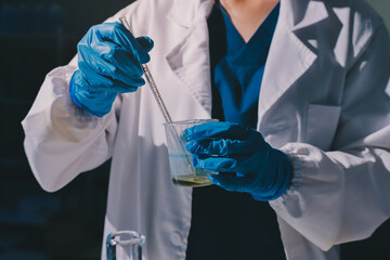 Scientist pipetting medical samples into microplate in laboratory