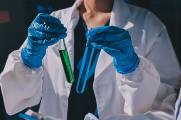Scientist pipetting medical samples into microplate in laboratory