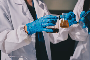 Scientist pipetting medical samples into microplate in laboratory