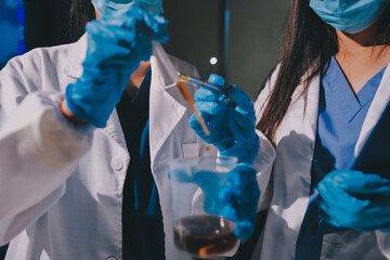 Scientist pipetting medical samples into microplate in laboratory