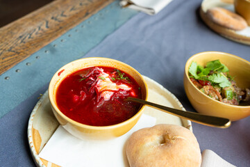 Borscht or borsch in bowl, Ukrainian beetroot soup. Red chowder thick borscht with sour cream