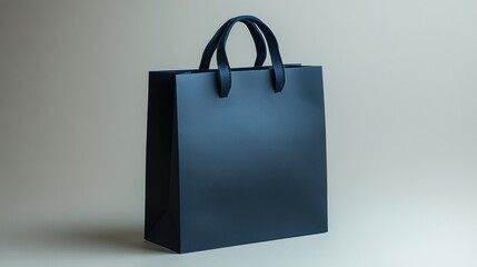 A matte navy blue paper bag with bold edges on a light grey background 