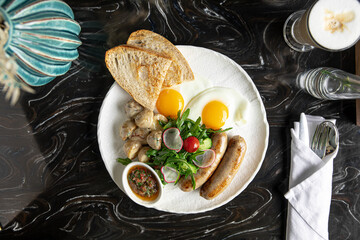 Portion of breakfast with sausages and fried eggs