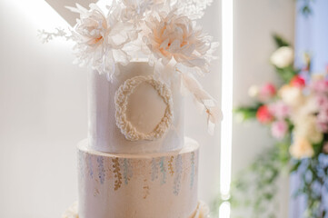 Wedding day. A large and delicious wedding cake on the photo zone in the festive atmosphere.