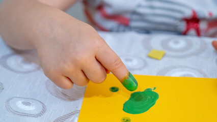 Colorful Finger Painting Activity for Kids with Bright Yellow Paint and Creative Learning Environment on White Background, Early Childhood Education Concept
