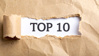 Torn paper revealing text Top 10. Business concept.