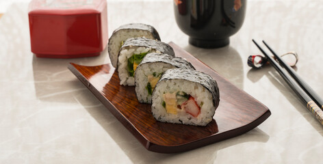 makizushi on a wooden plate. Japanese cuisine.