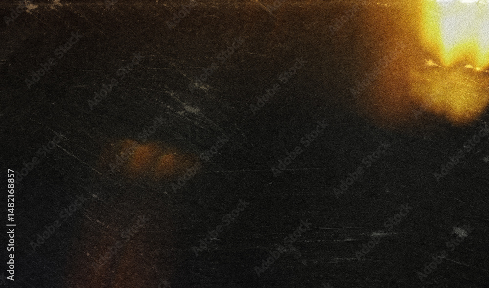 Poster the image shows a blurred, out-of-focus shot of a dark object against a bright orange background. th